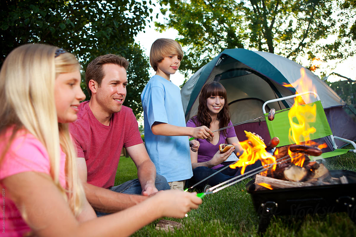 Camping: Family Cooking Hot Dogs Over Fire