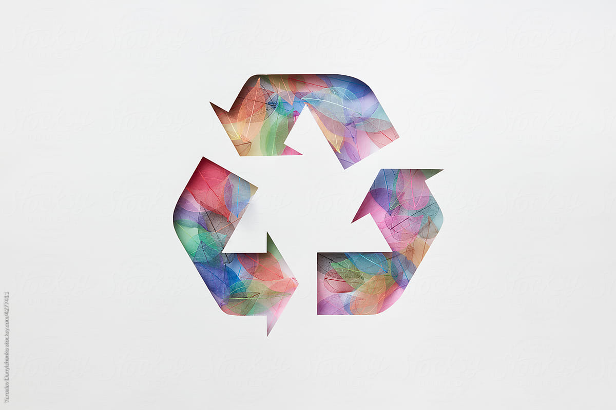 Recycle sign made of colored leaves