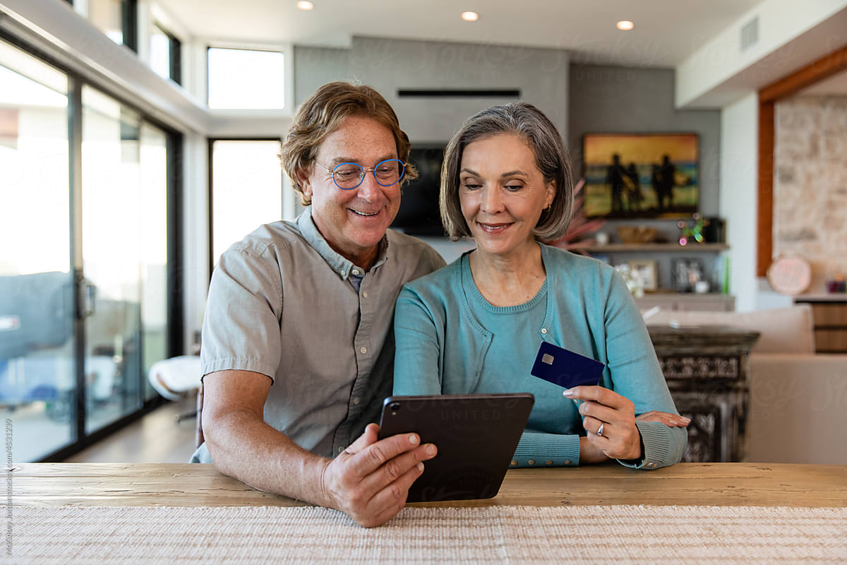 Older Couple Uses Credit Card While Shopping Online