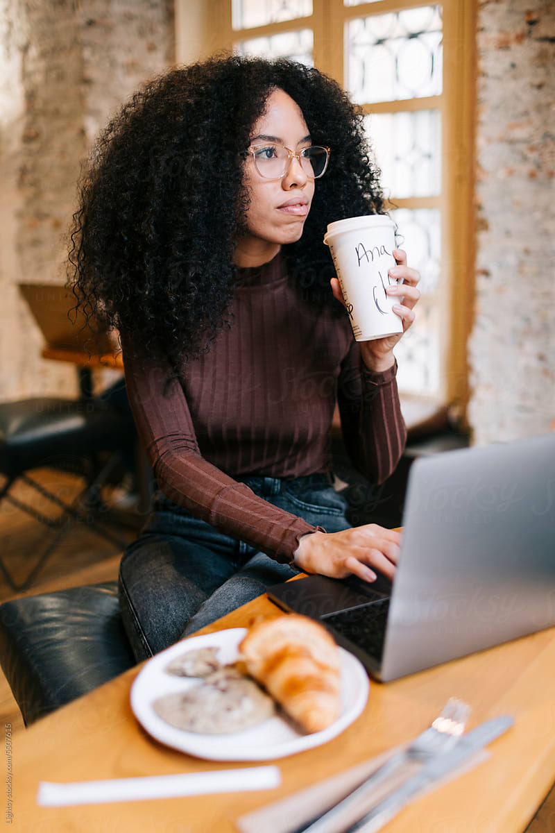 Woman having a coffee and working