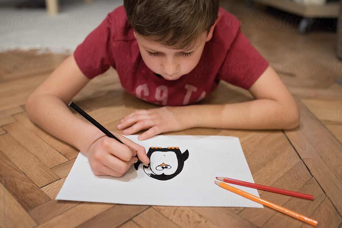 Boy drawing a penguin