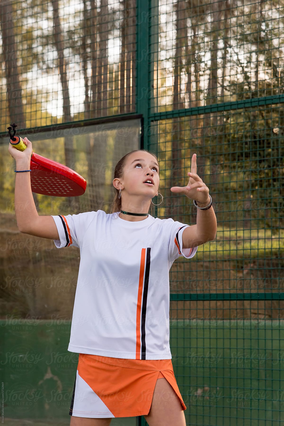 Young girl playing paddle tennis outdoors
