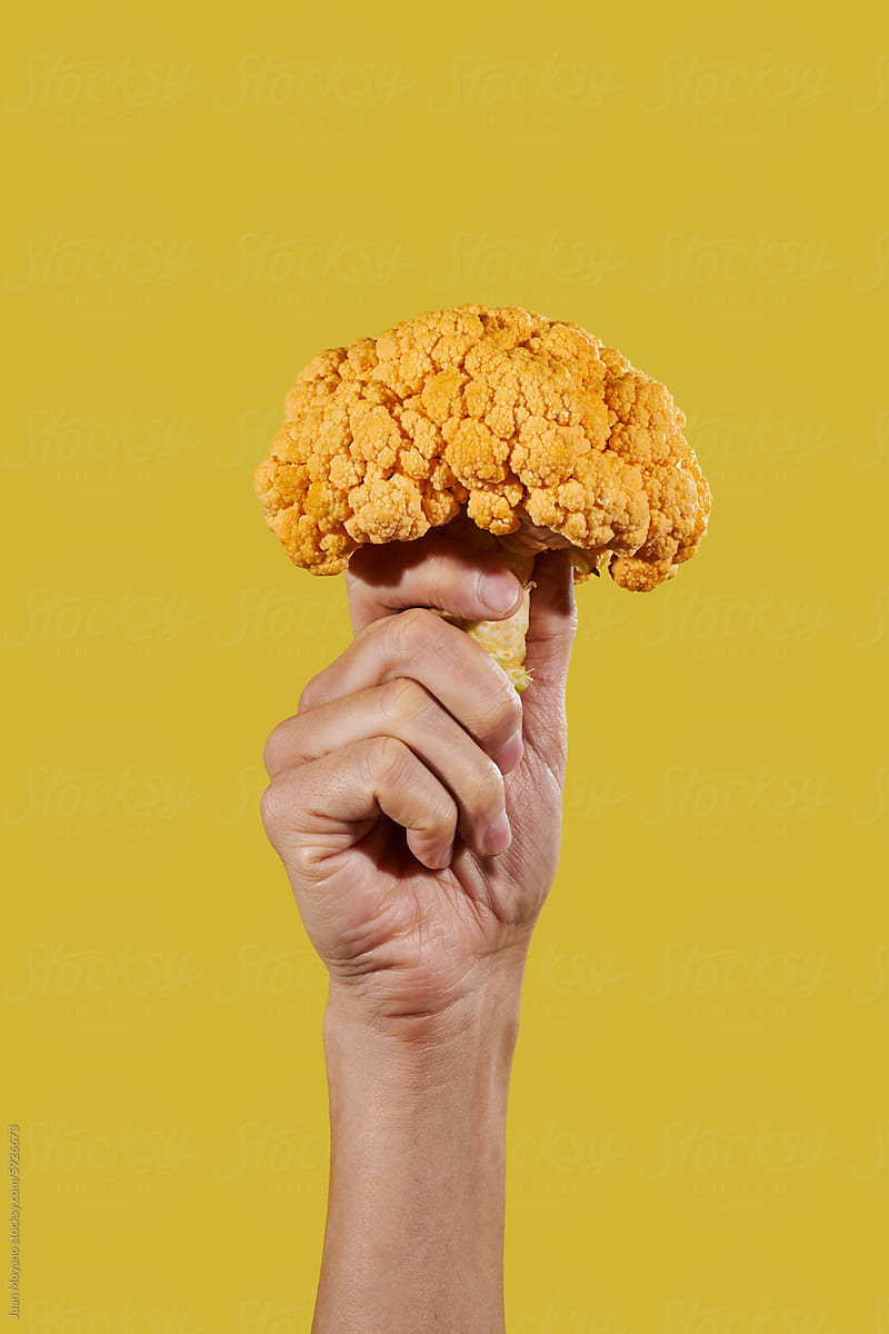 holding an orange cauliflower