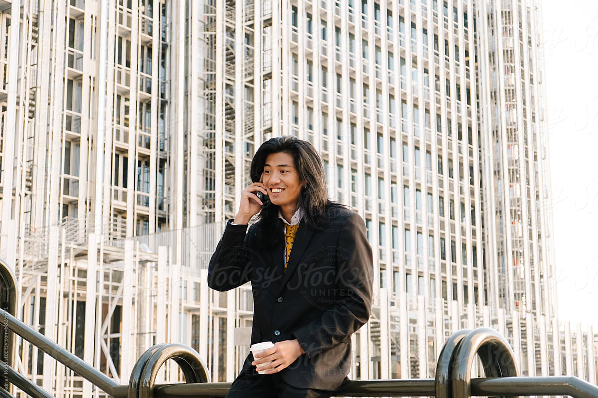 Businessman smiling while talking on the phone.