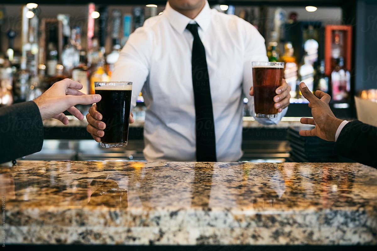 Restaurant: Bartender Serving Up Beers To Customers