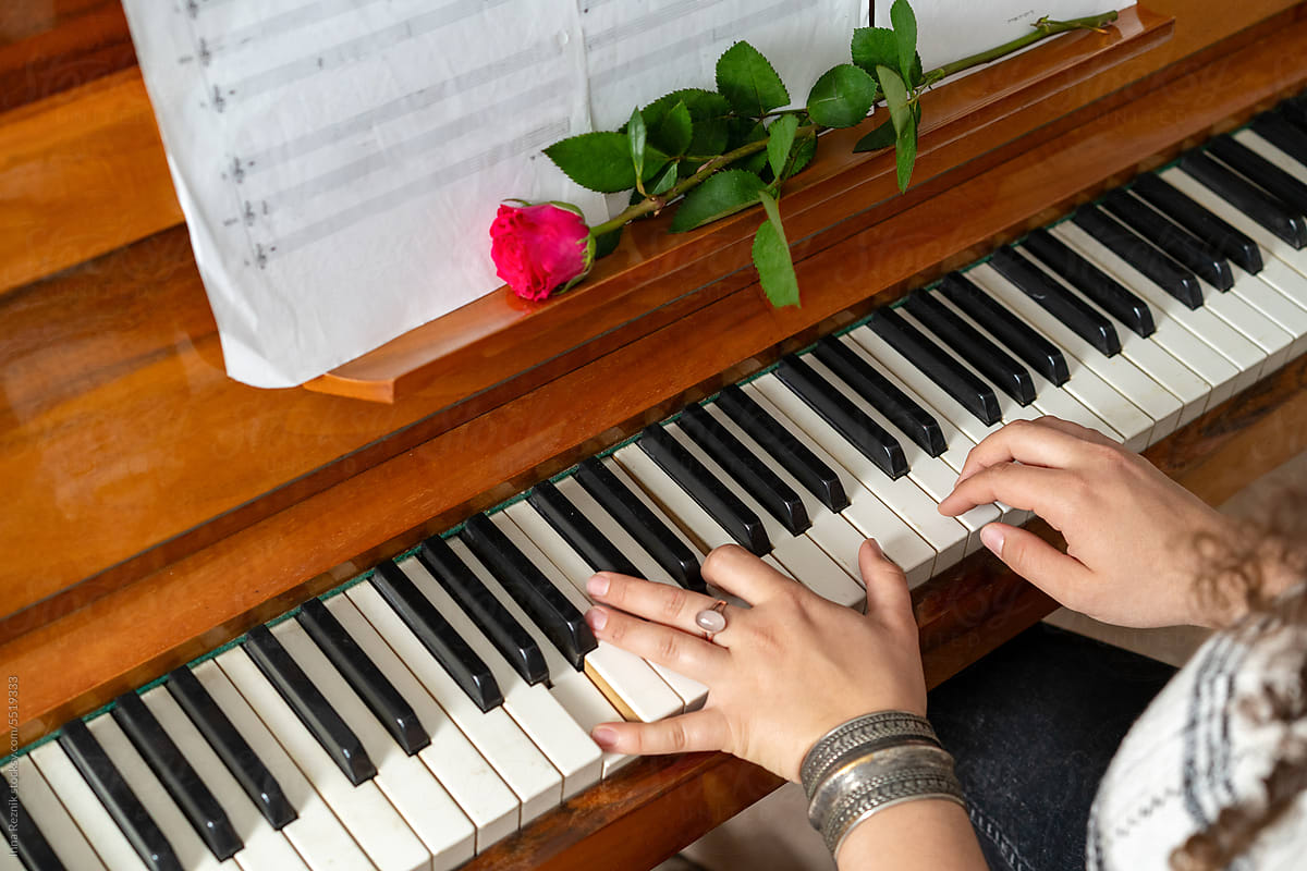 Piano Keys, Female Hands, Music Book, and Rose.