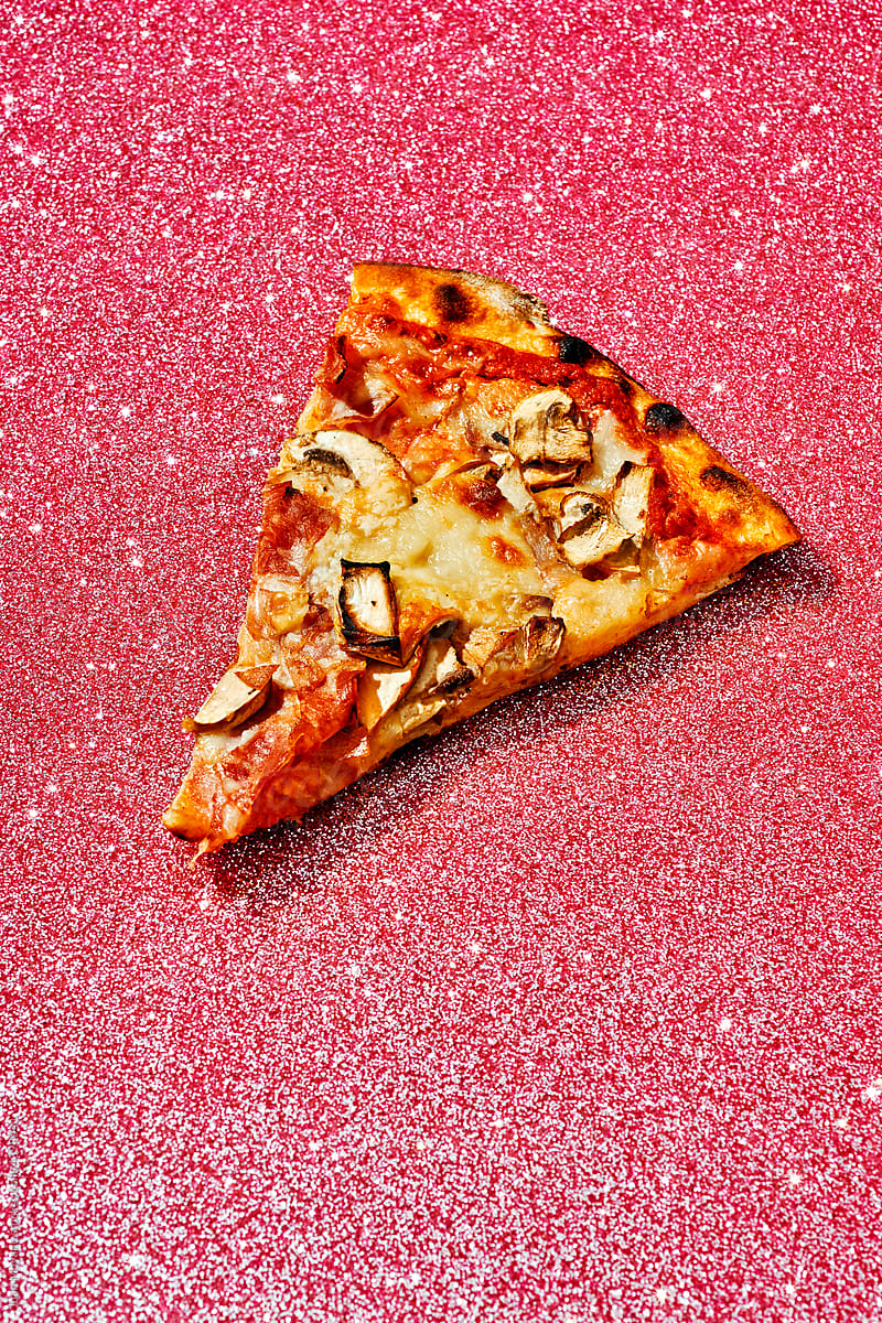 piece of pizza on a pink glitter background