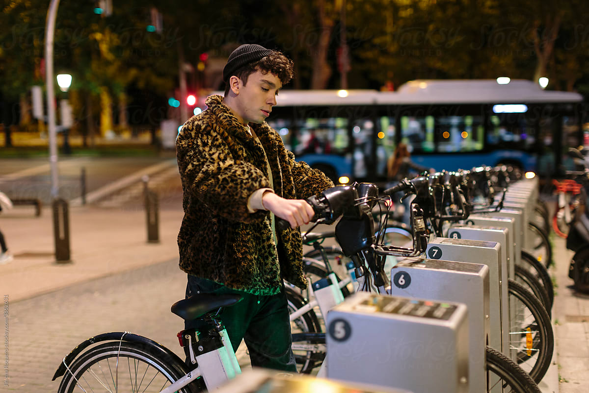 Gen-z non-binary person renting a city bike