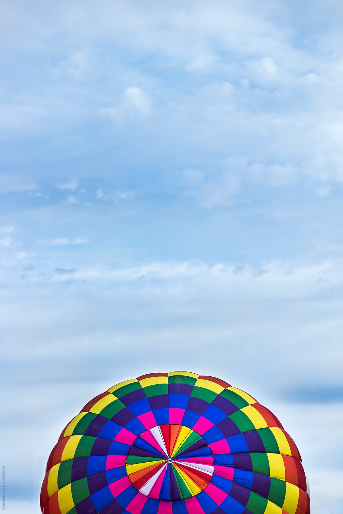 Calorful pattern of a hot air balloon against clouds
