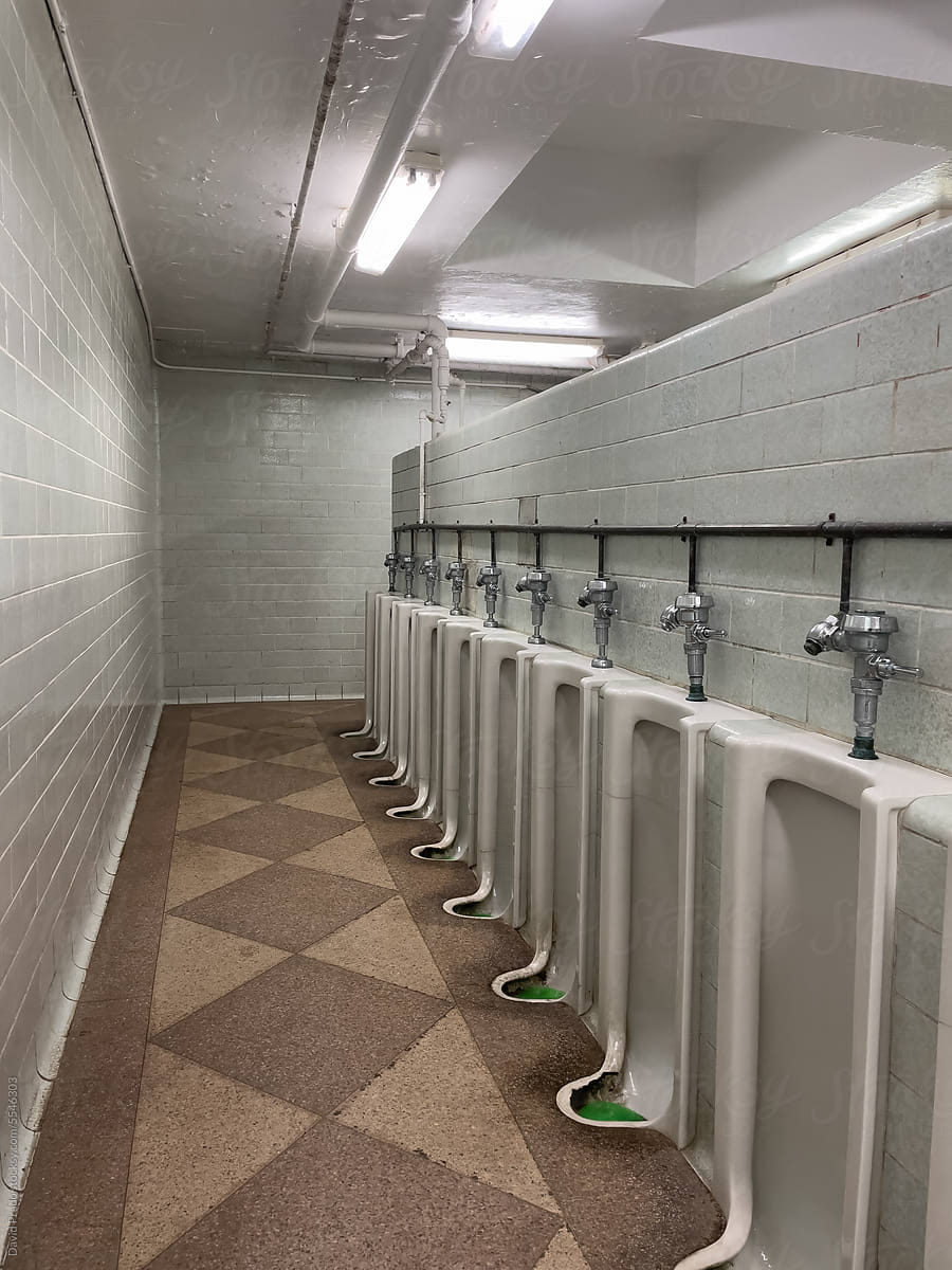 interior of  public men toilet bathroom with tiled walls