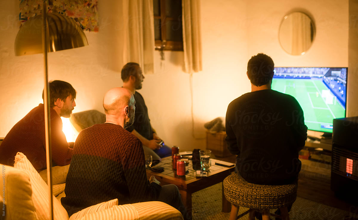 Friends playing football video game together