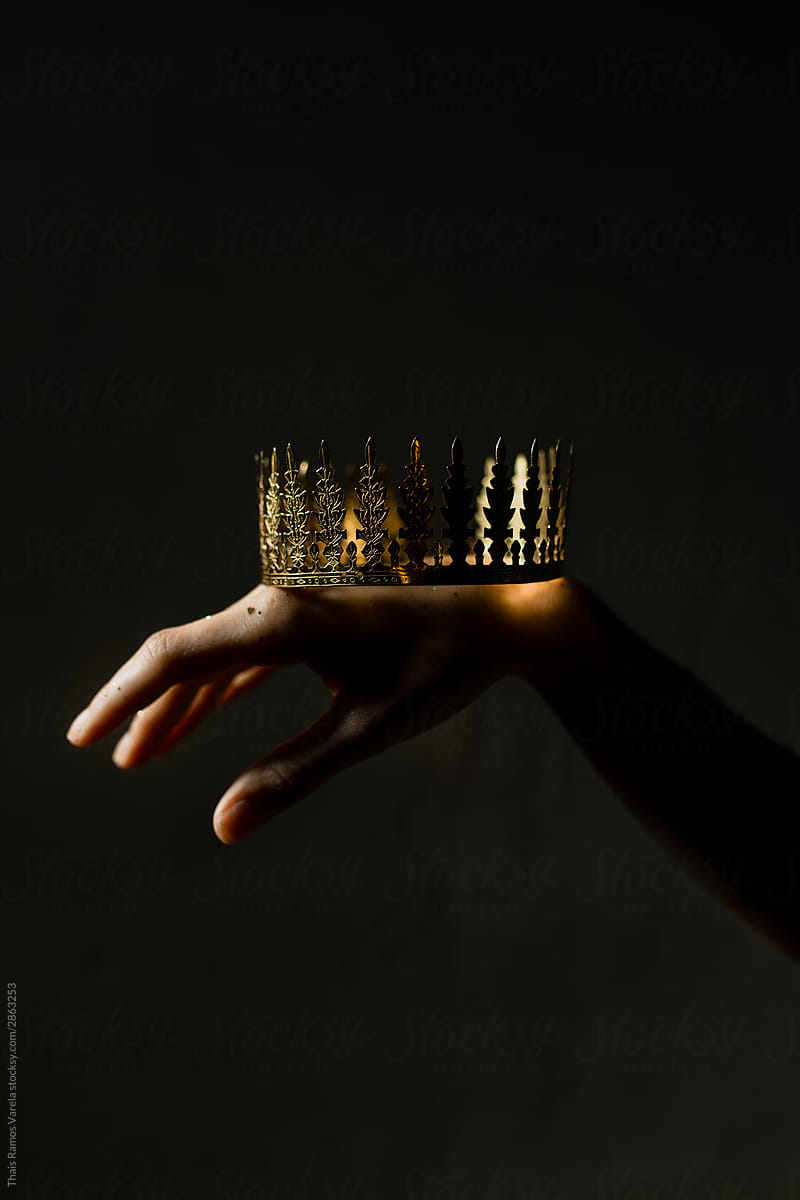 golden crown on a hand.
