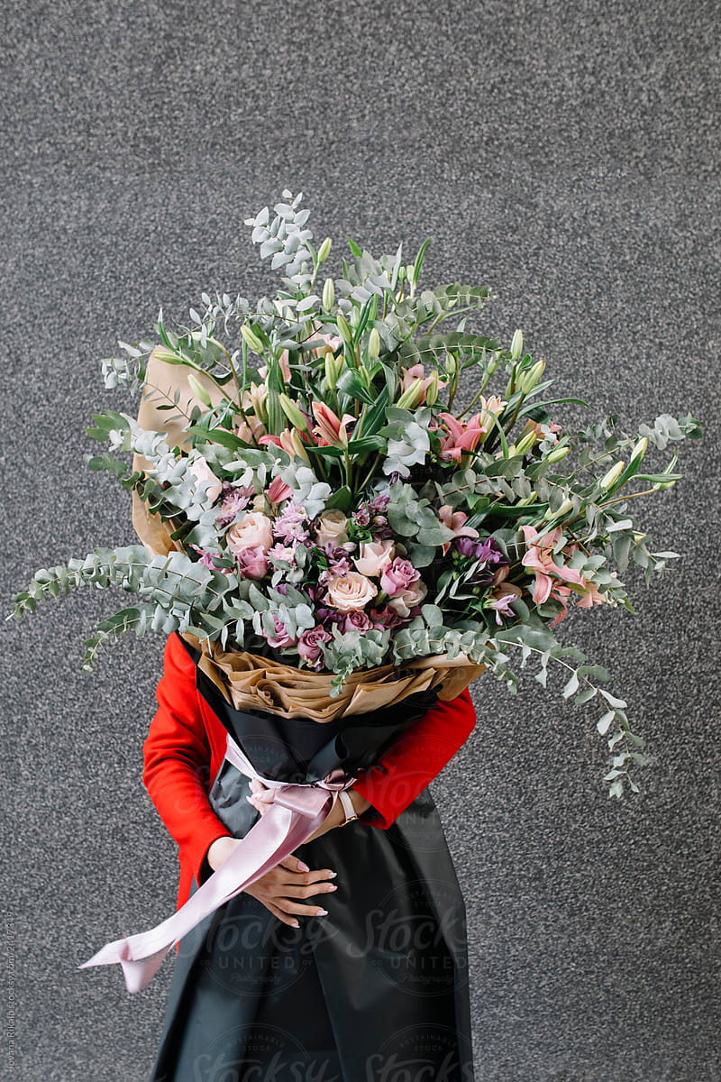 Young woman holding big bouquet