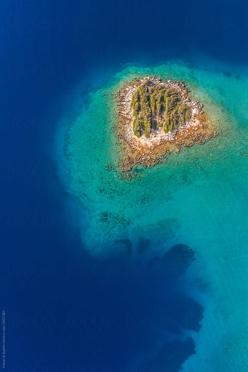 aerial view if tiny island in turquoise sea