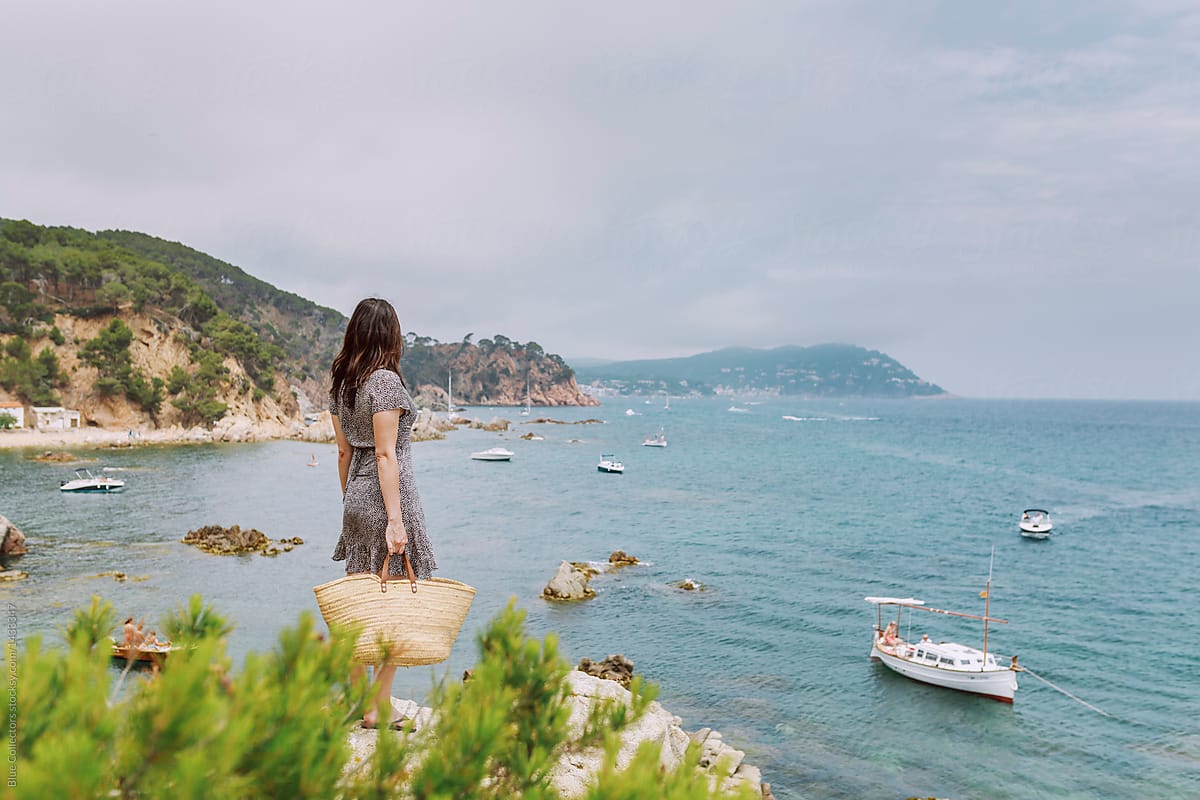 Woman watching the sea on an idyllic Mediterranean coast in the summertime