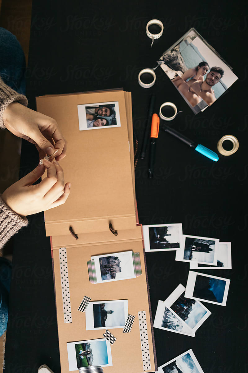Woman Making A Scrapbook With Polaroid Photos by Stocksy Contributor  Pedro Merino - Stocksy
