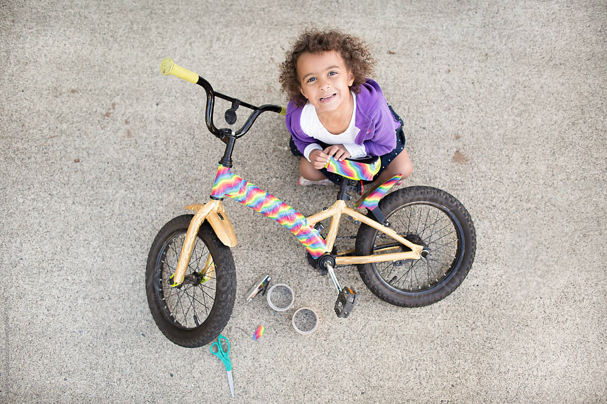 Top down view of girl decorating bike