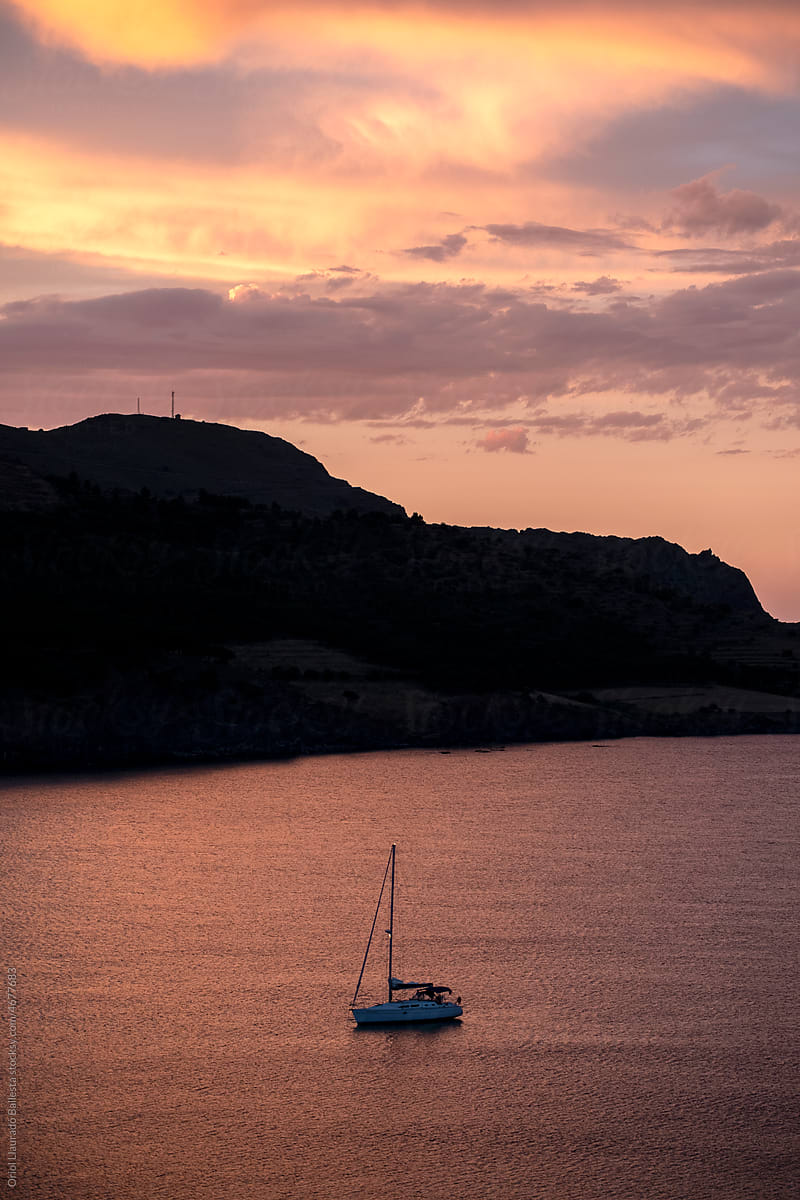 Sailboat Resting In A Bay At Sunset