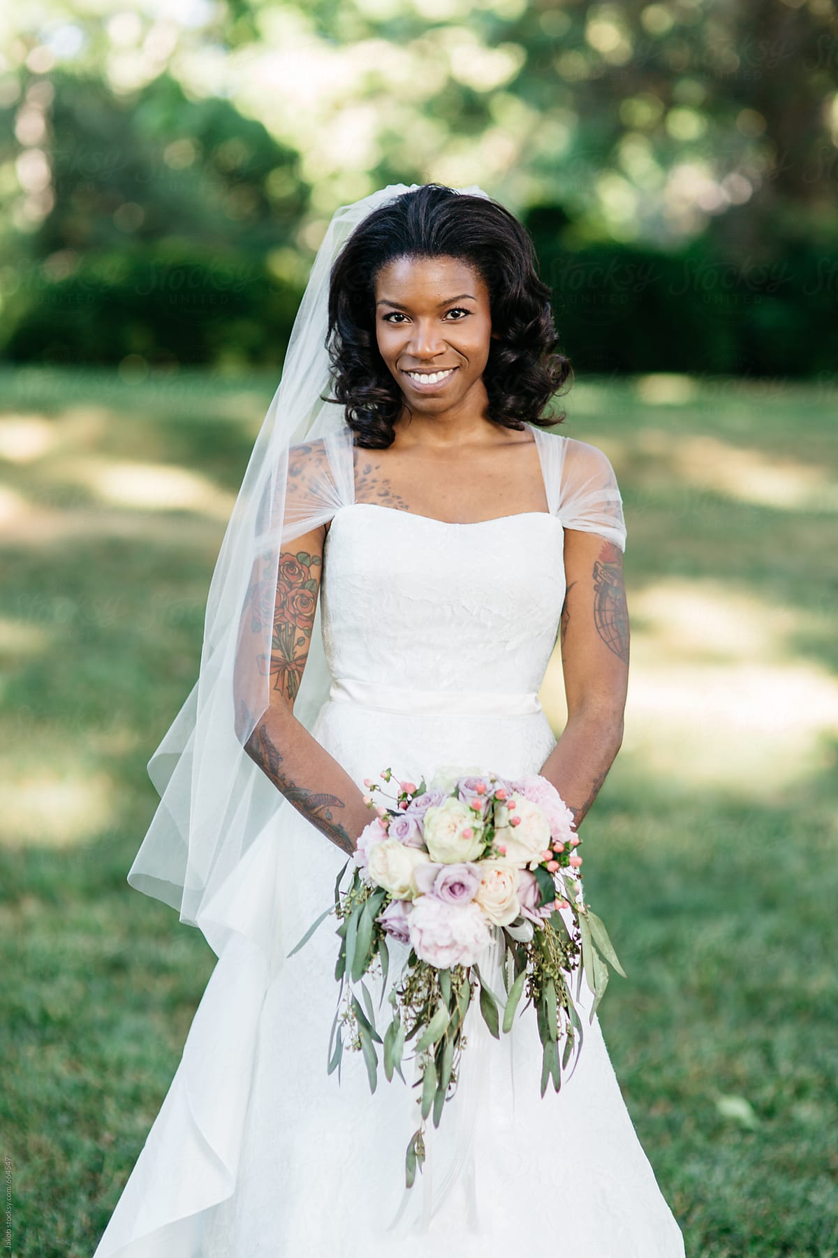 Beautiful African American Bride Holding A Bouquet Of Flowers