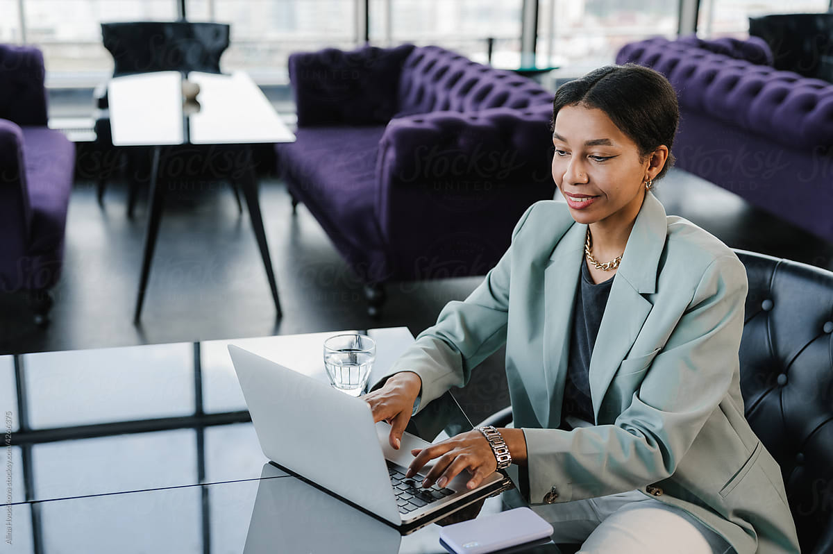 Woman Sitting At Desk With Laptop by Stocksy Contributor Alina