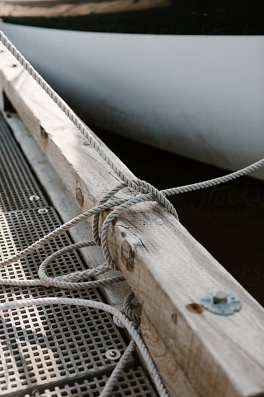 detail of ropes tied up to dock boat in marina