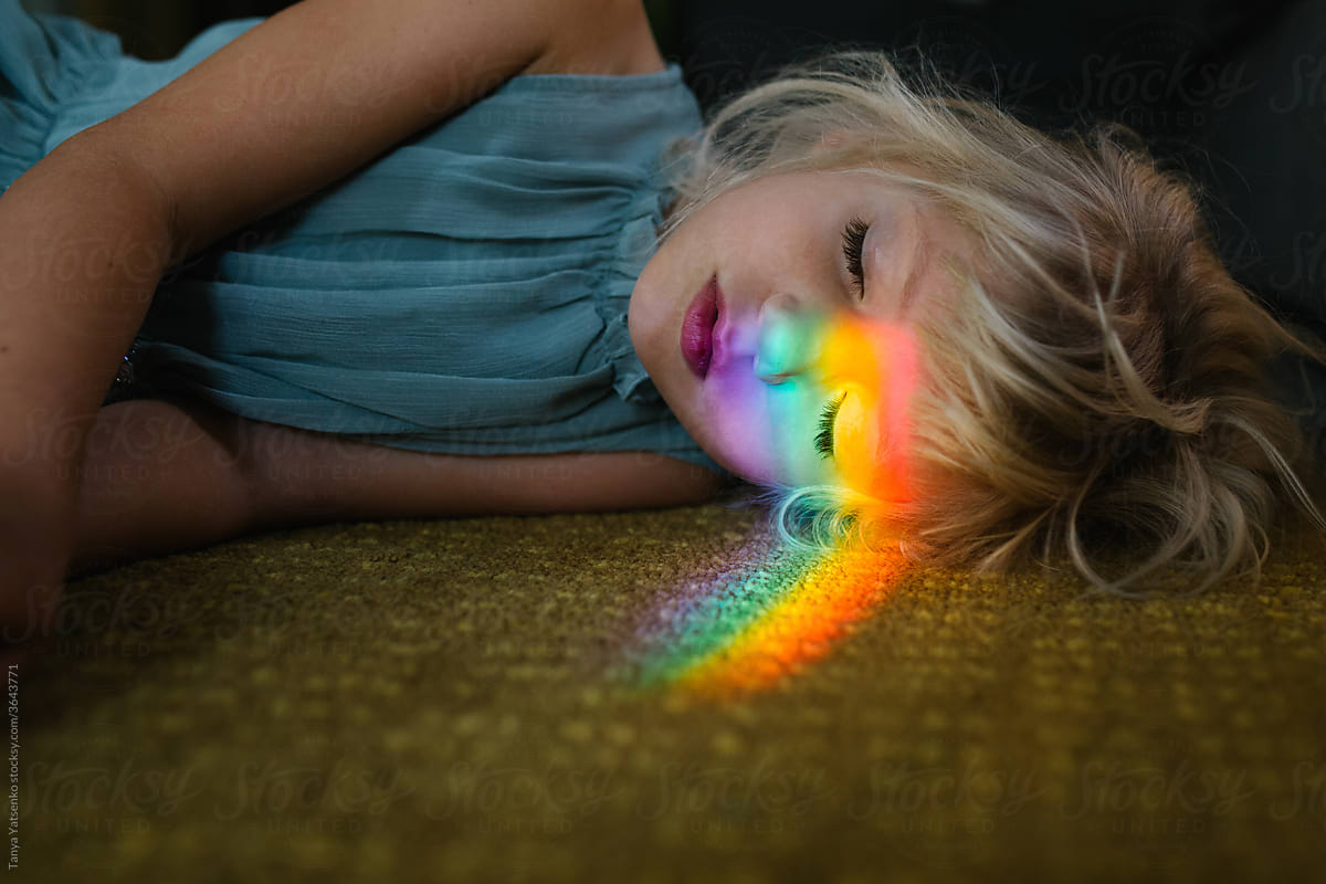 Portrait of a girl with the  light of rainbow on her face