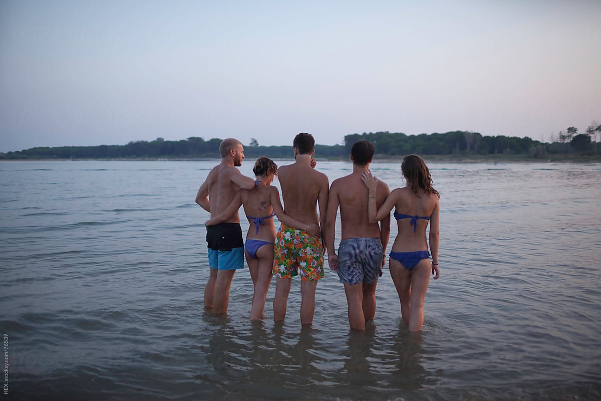 Friends Hugging In The Sea At Sunset Back View By Stocksy Contributor Mattia Stocksy 