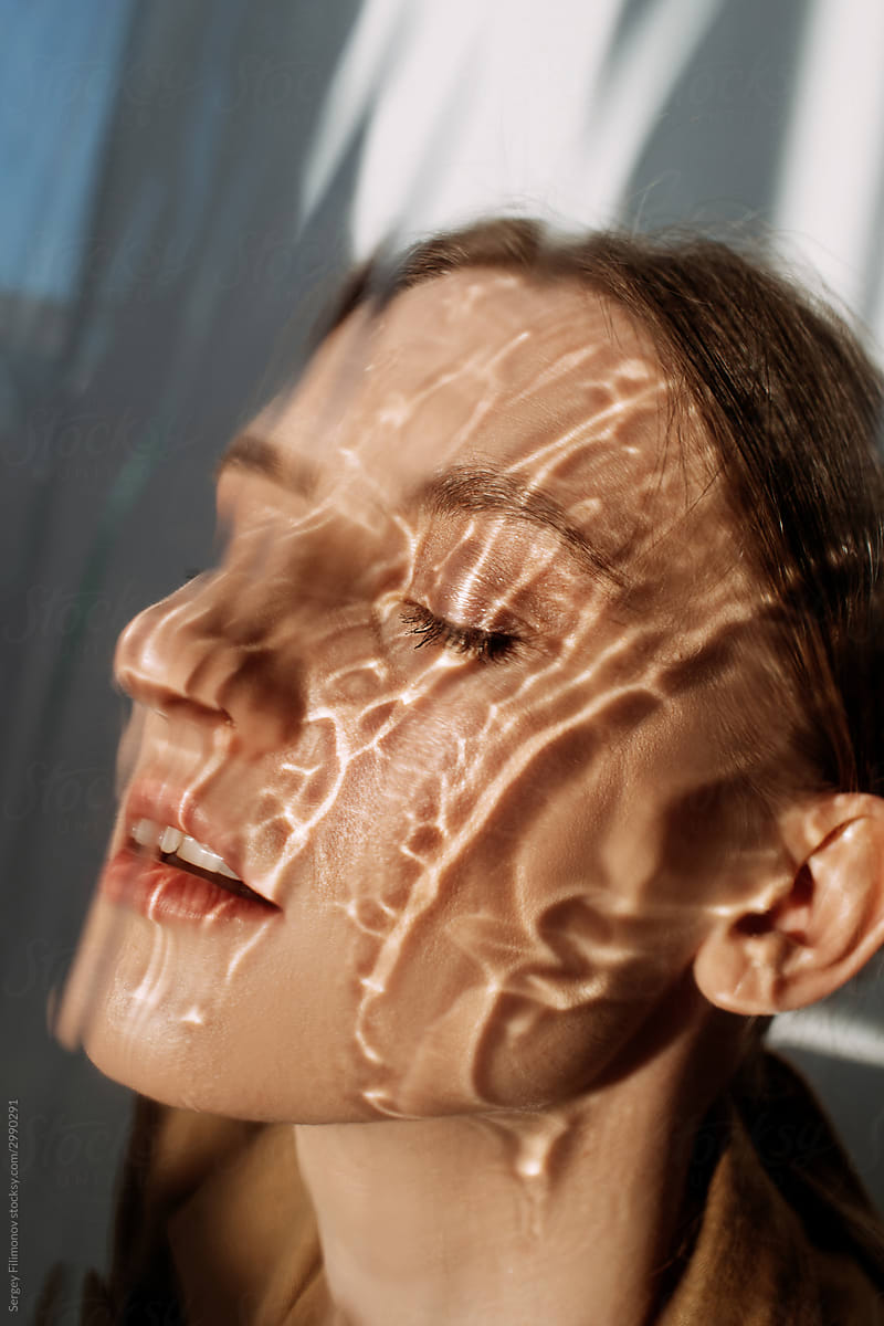 Female model with reflection of water on face