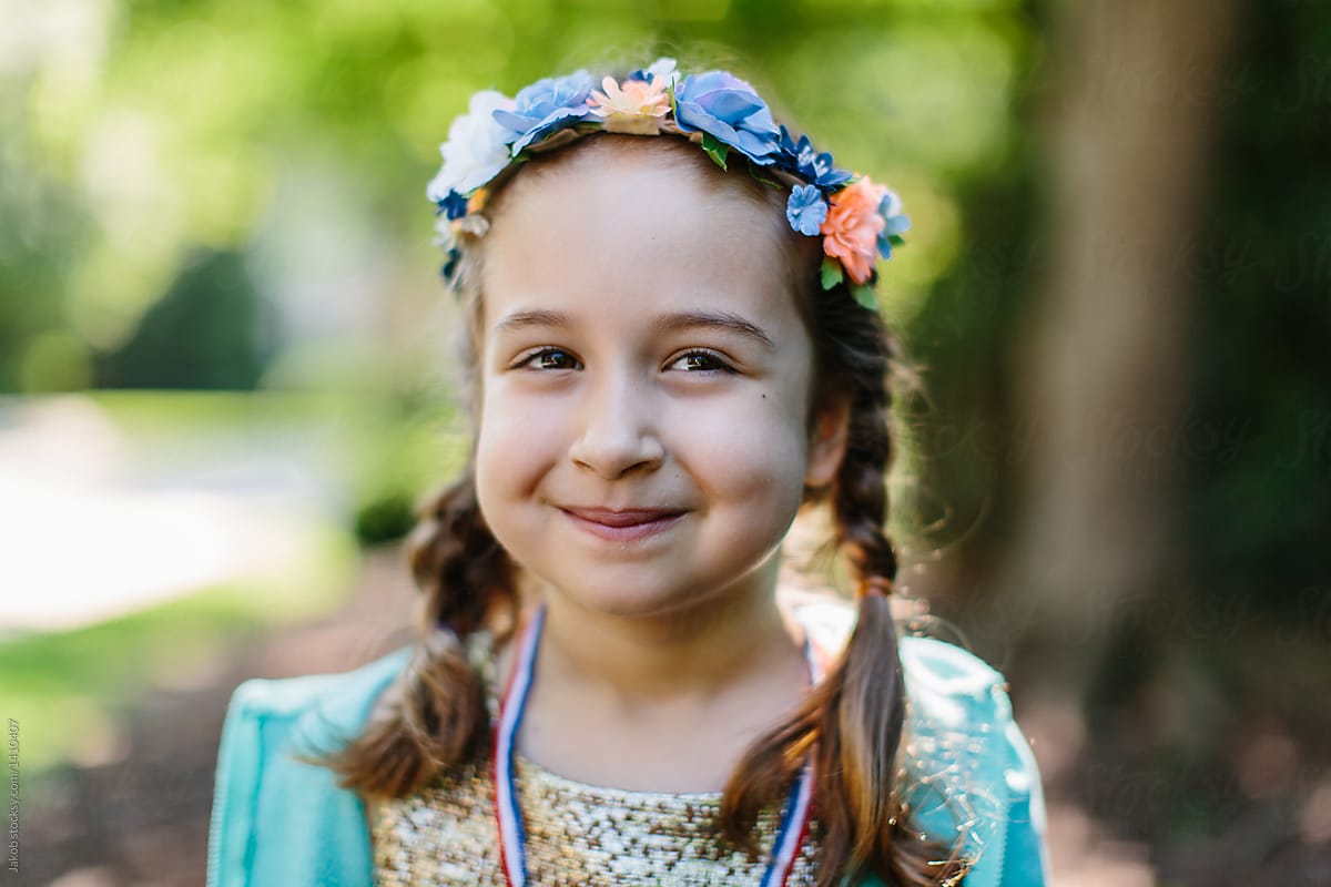 Portrait of a cute young girl with pigtails wearing a flower headband