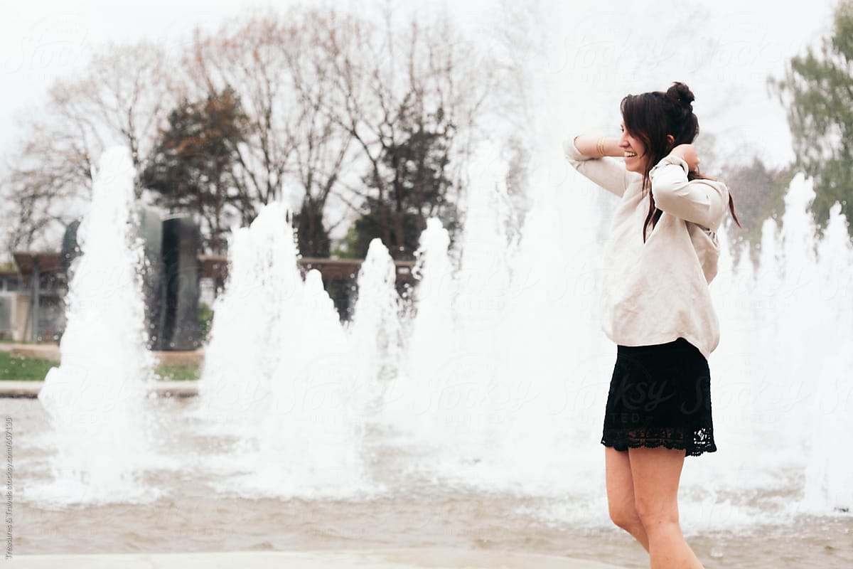 Young fashionable female outdoors at a fountain