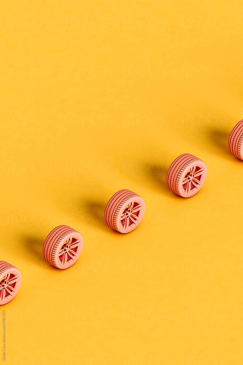 a row of pink wheel on a yellow background