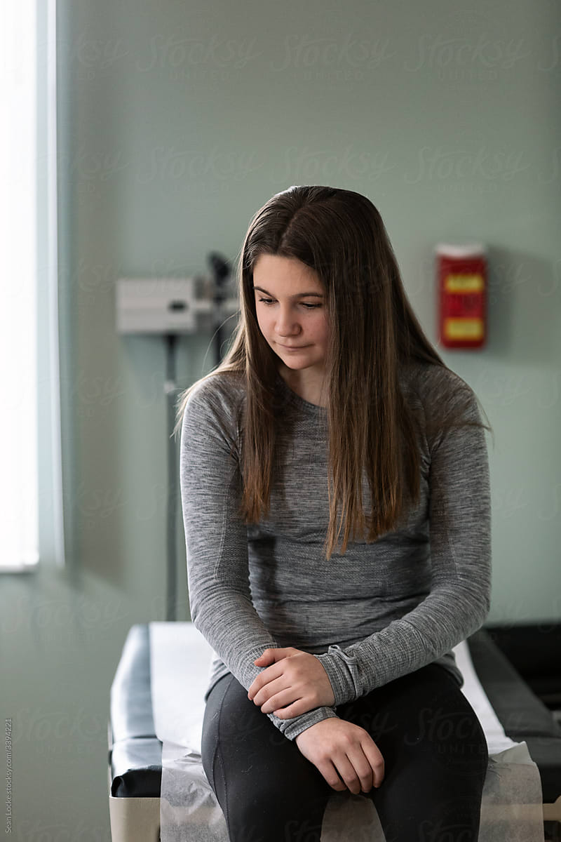 Exam Teen Girl Sits On Exam Table Waiting For Physician By Sean Locke