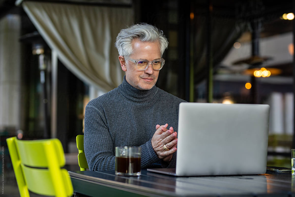 Man Looks Pleased At The Work He Has Done On His Computer