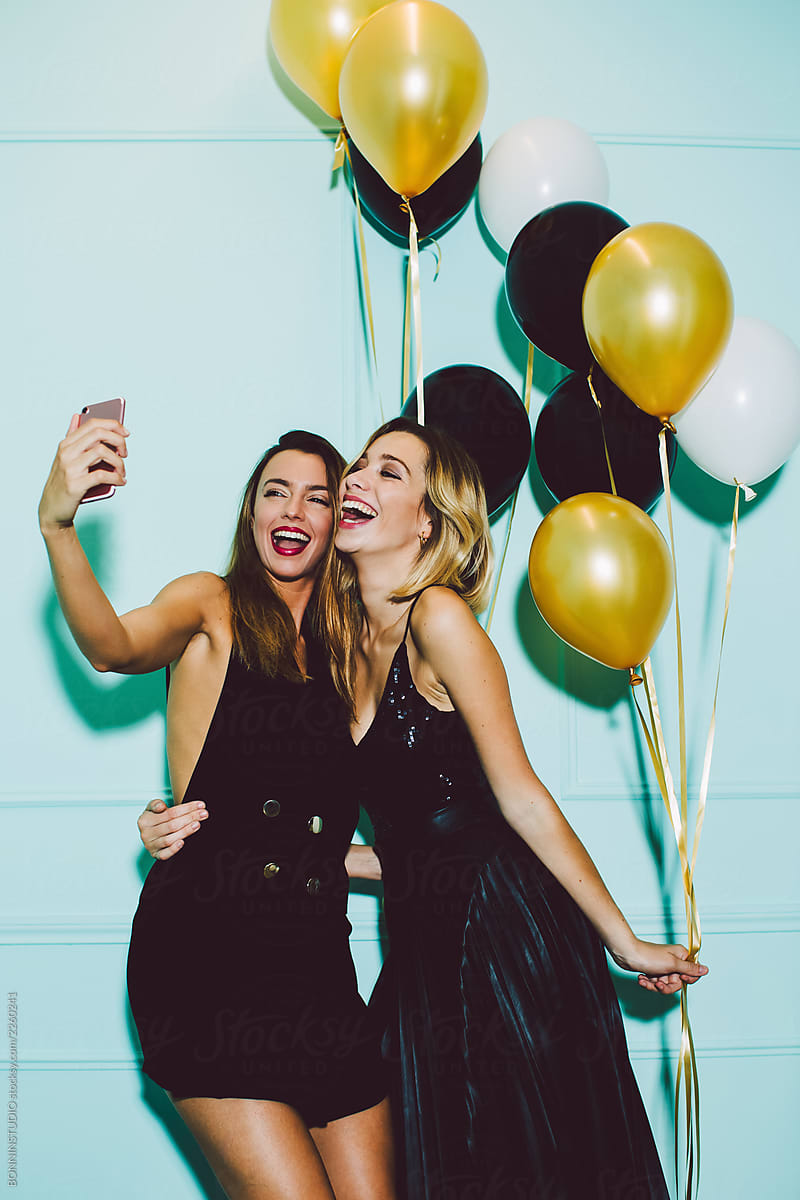 Beautiful women taking a selfie in a New Year party celebration.