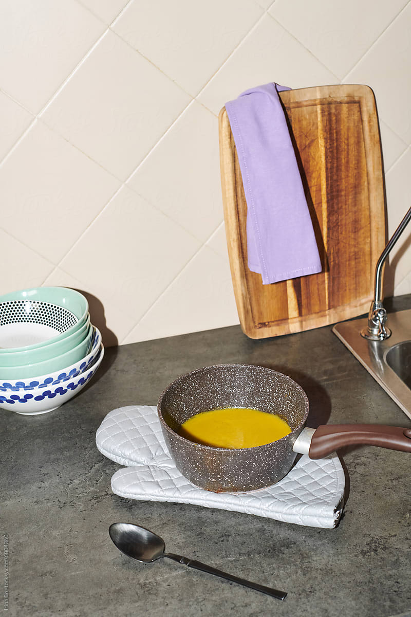 cream of soup in a ladle stands on a potholder