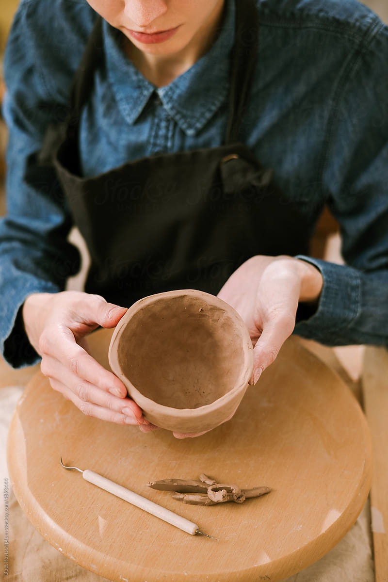 Closeup photo of a young female ceramist at work