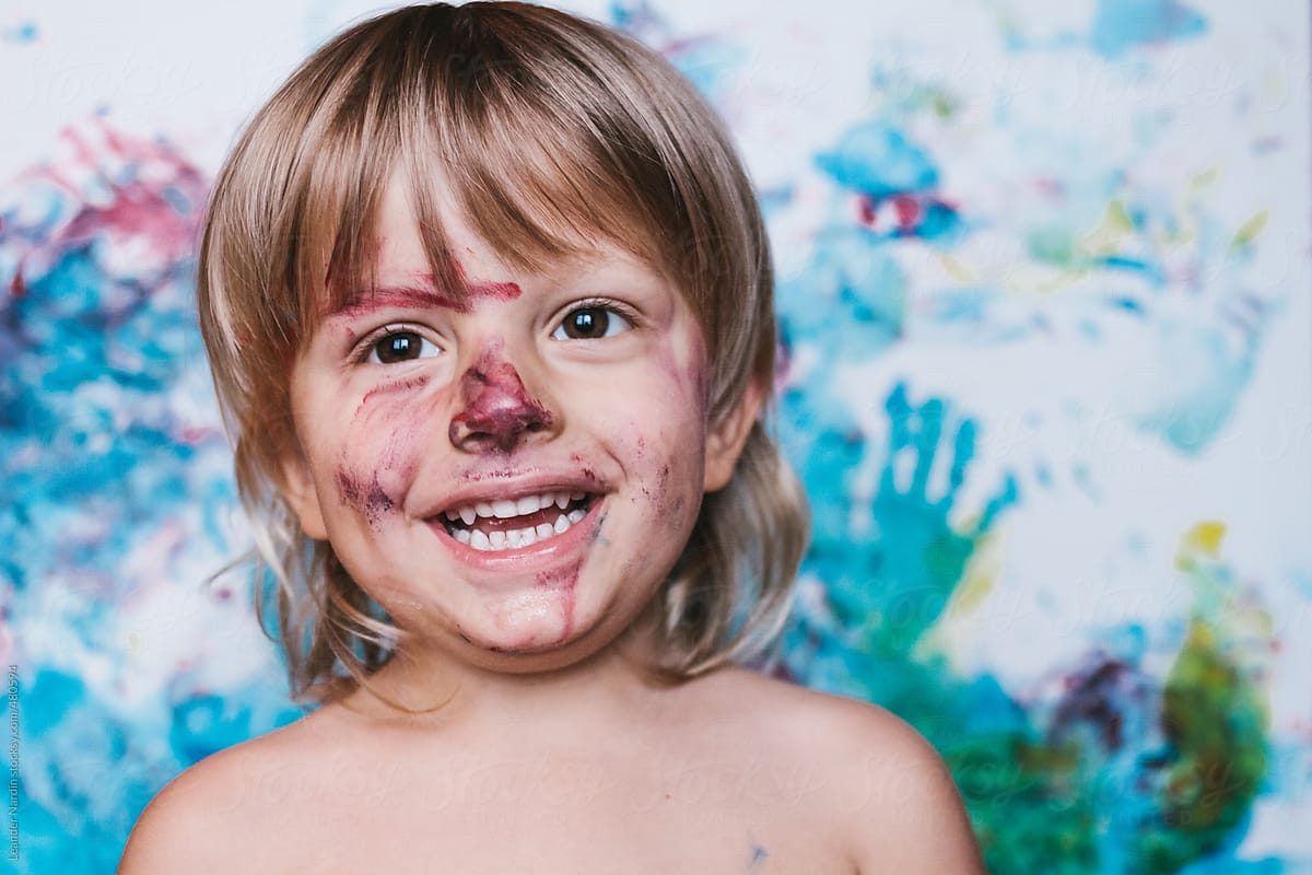 Portrait Of A Smiling Colorfully Painted Toddler Del Colaborador De