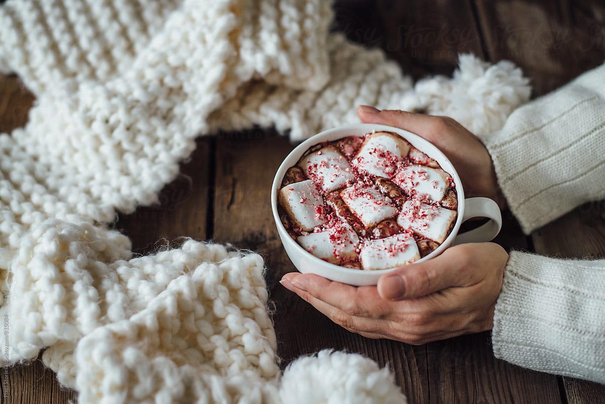 Woman holding marshmallow hot cocoa cup