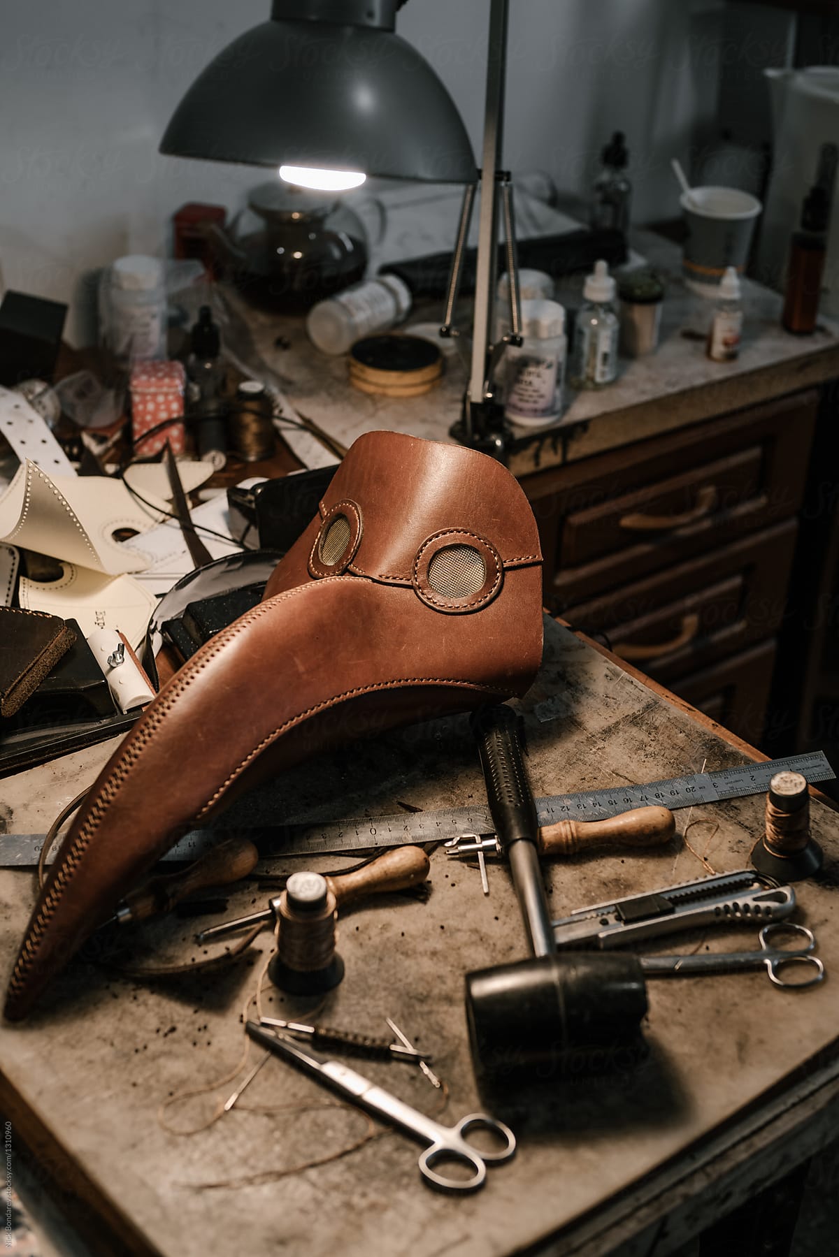 Close-up of Plague Doctor Mask and tools at manufacture of craft leather products