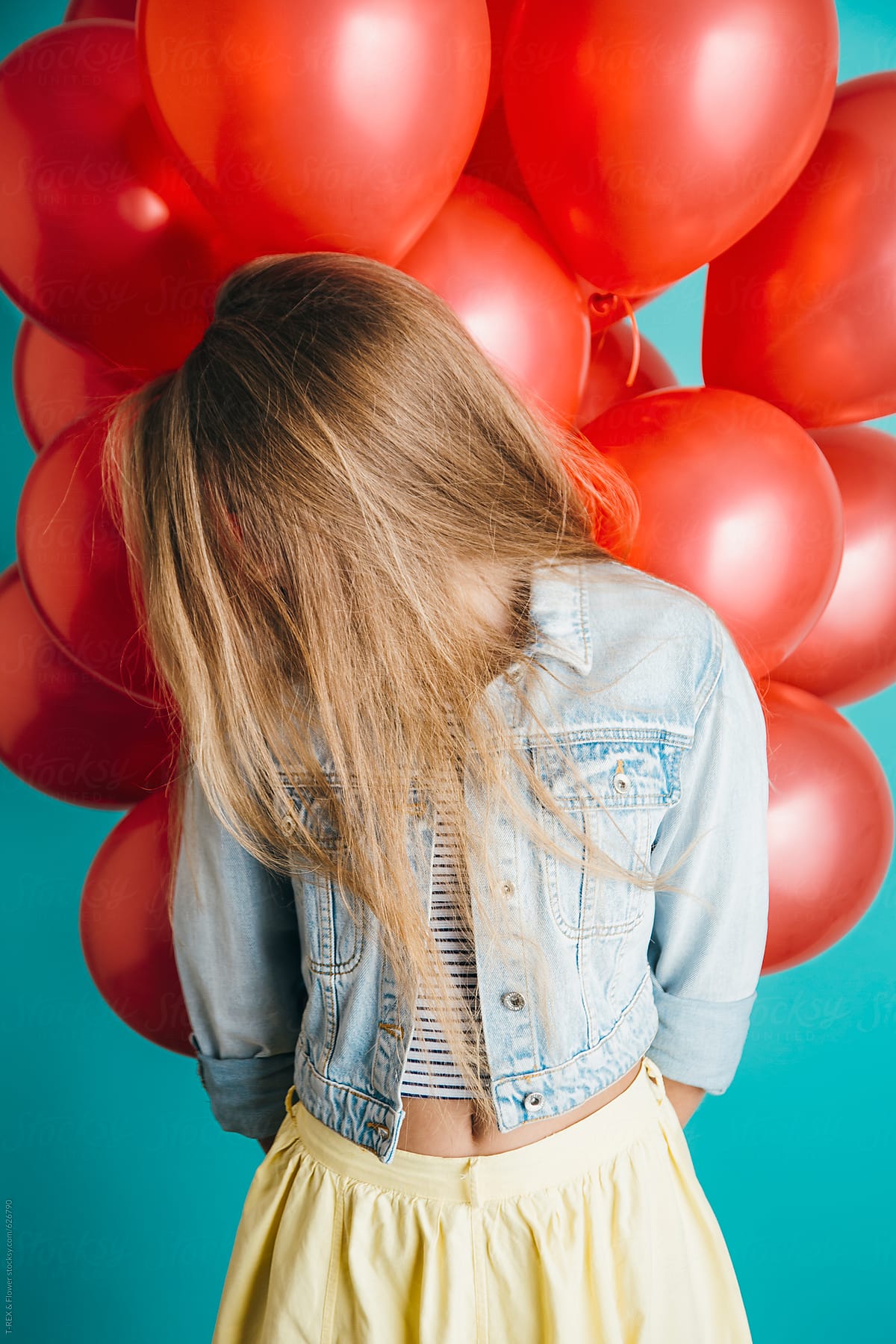 Stylish female with bright red balloons