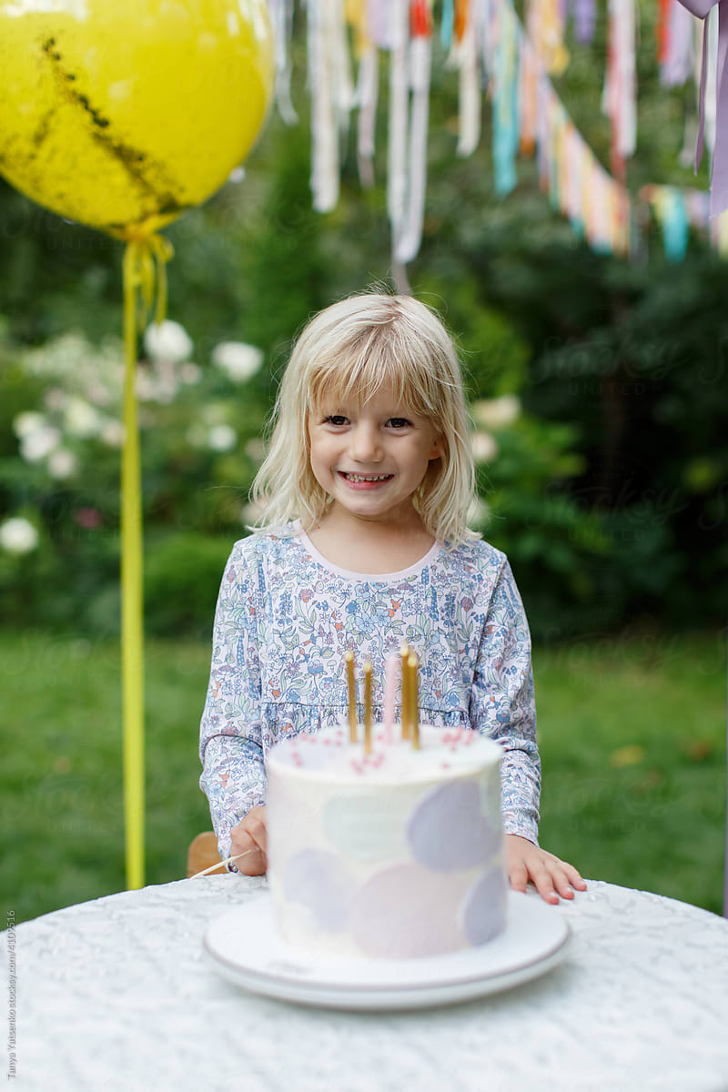A birthday smiling girl with a cake