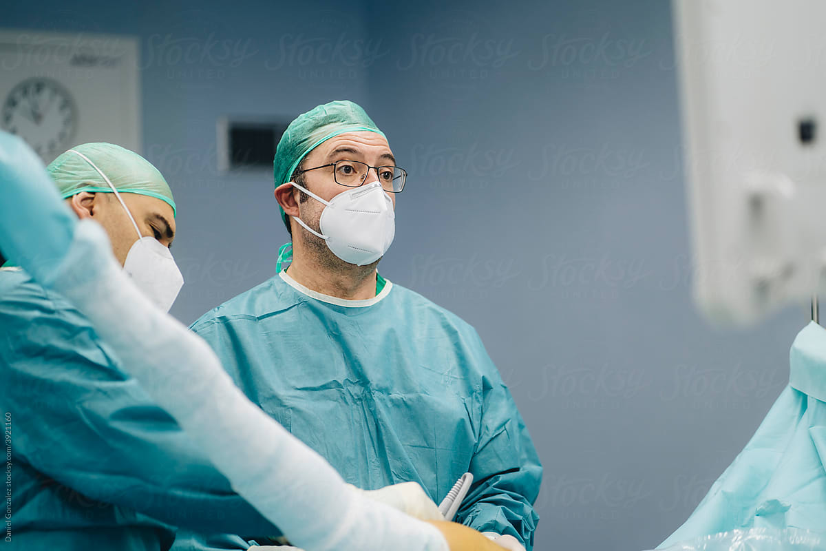 Surgeon with assistant in operating room
