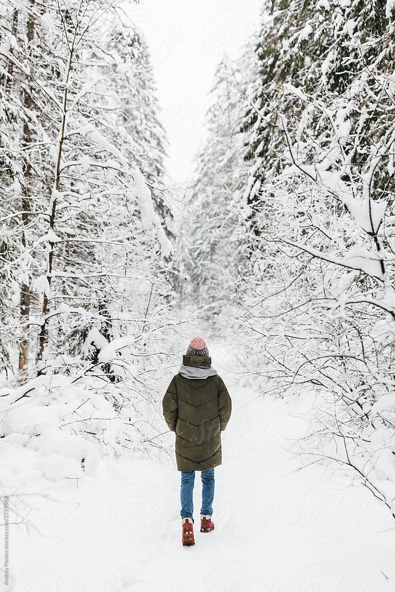 Woman among snowy pines