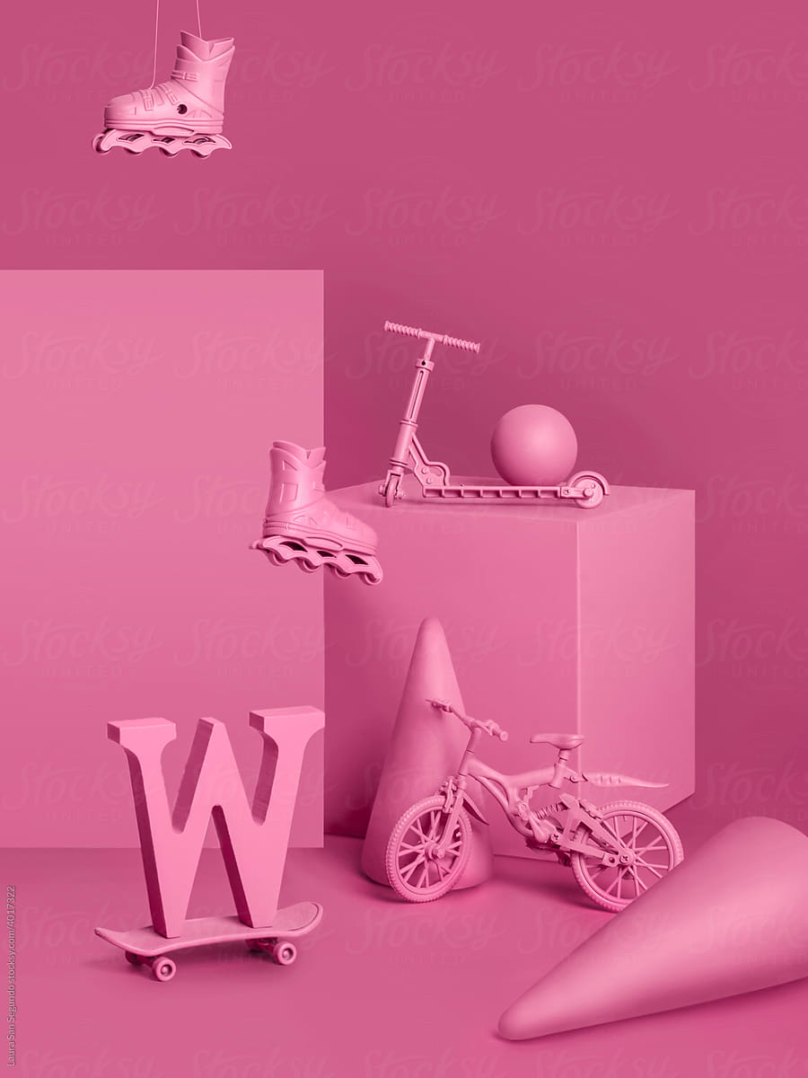 Pink monochromatic still life with wheeled objects