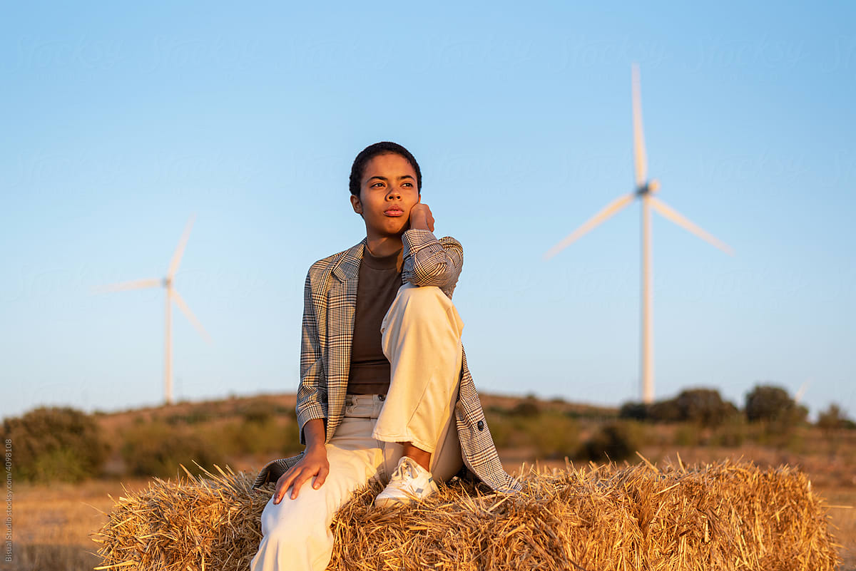 Stylish black woman admiring countryside field