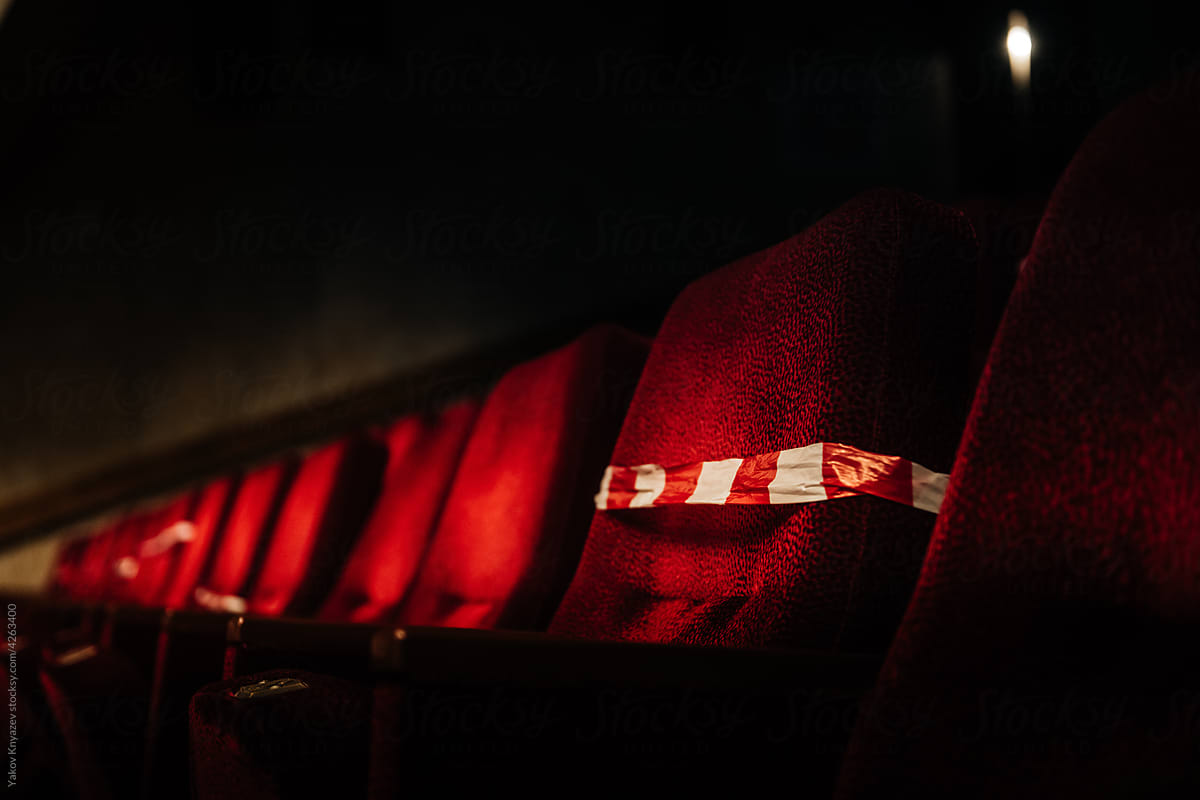 red velvet seats in the theater crossed with tape