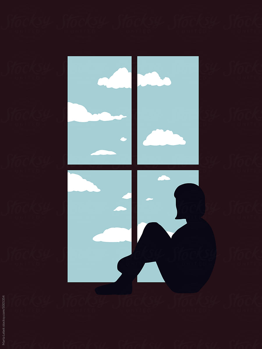 Sad girl sitting at the window
