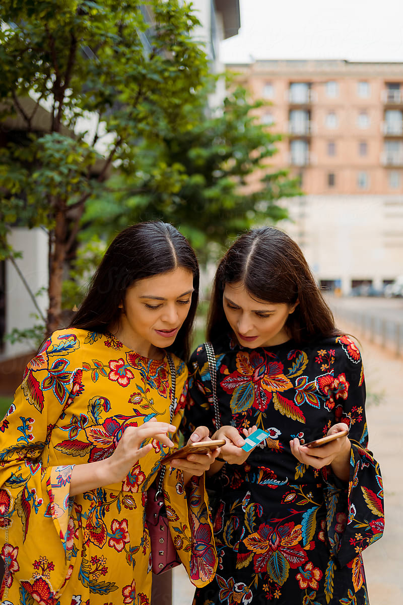 Women using a smartphone for online shopping outdoor