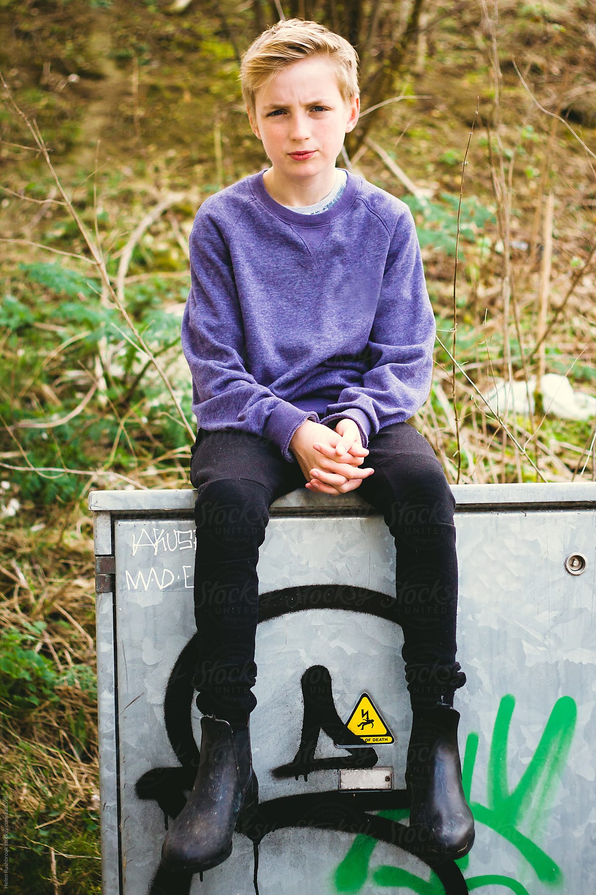 «Teenage Boy Sitting On An Electricity Cable Box, Outdoors» del ...