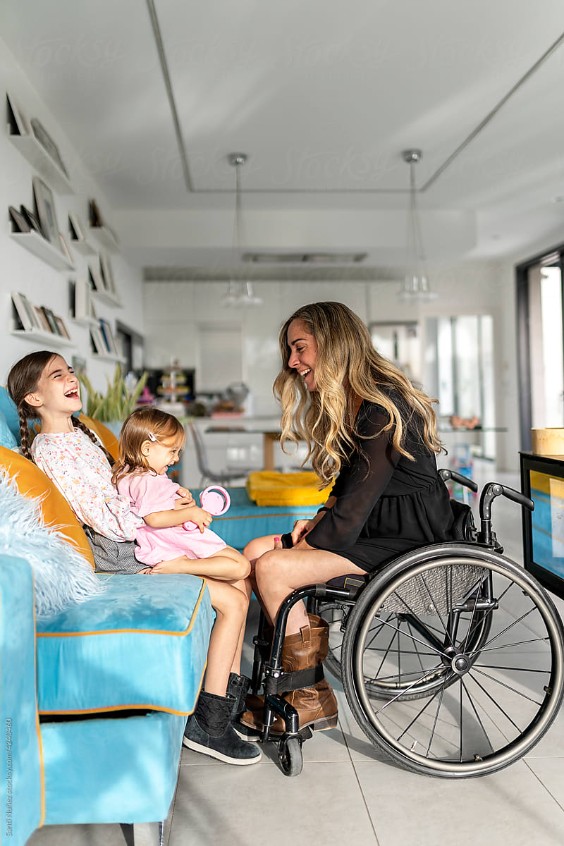 Mother in wheelchair playing with her daughter